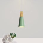 A slim green Clérachic cone pendant with its wood top is shown against a plain grey wall above two stone vases.