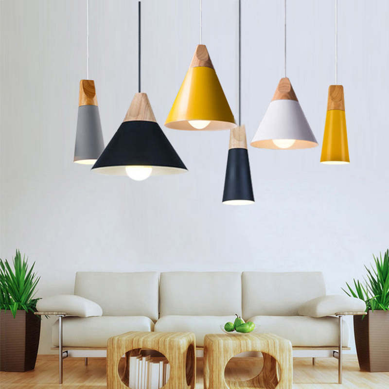 The six Clérachic cone pendant colors are grouped together above a white sofa in a bright living room.