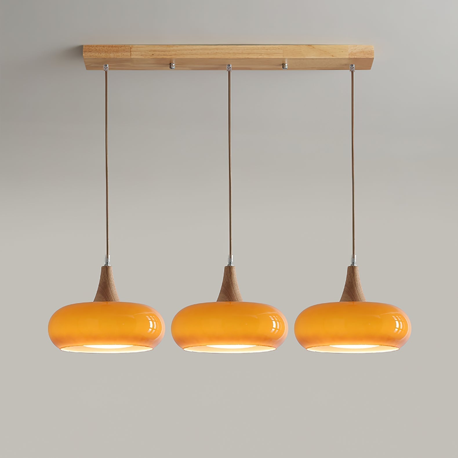 Clérachic Wood-Top Glass Pendant Light in three-head amber, a straight-on view showing the full drop of each braided cord.