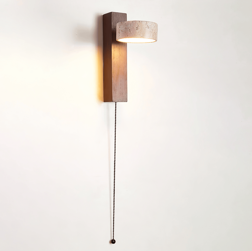 This Clérachic wall light with a walnut-coloured bar and a travertine head has a beaded pull cord hanging down a white wall.
