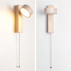 Two views of a Clérachic wall light in pale wood with a pull cord, one with its travertine head tilted up and lit, one with it turned flat.