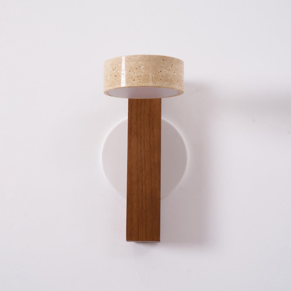 Switched off, this Clérachic wall light has a walnut-coloured bar and a travertine head with a white underside, on a round white plate.