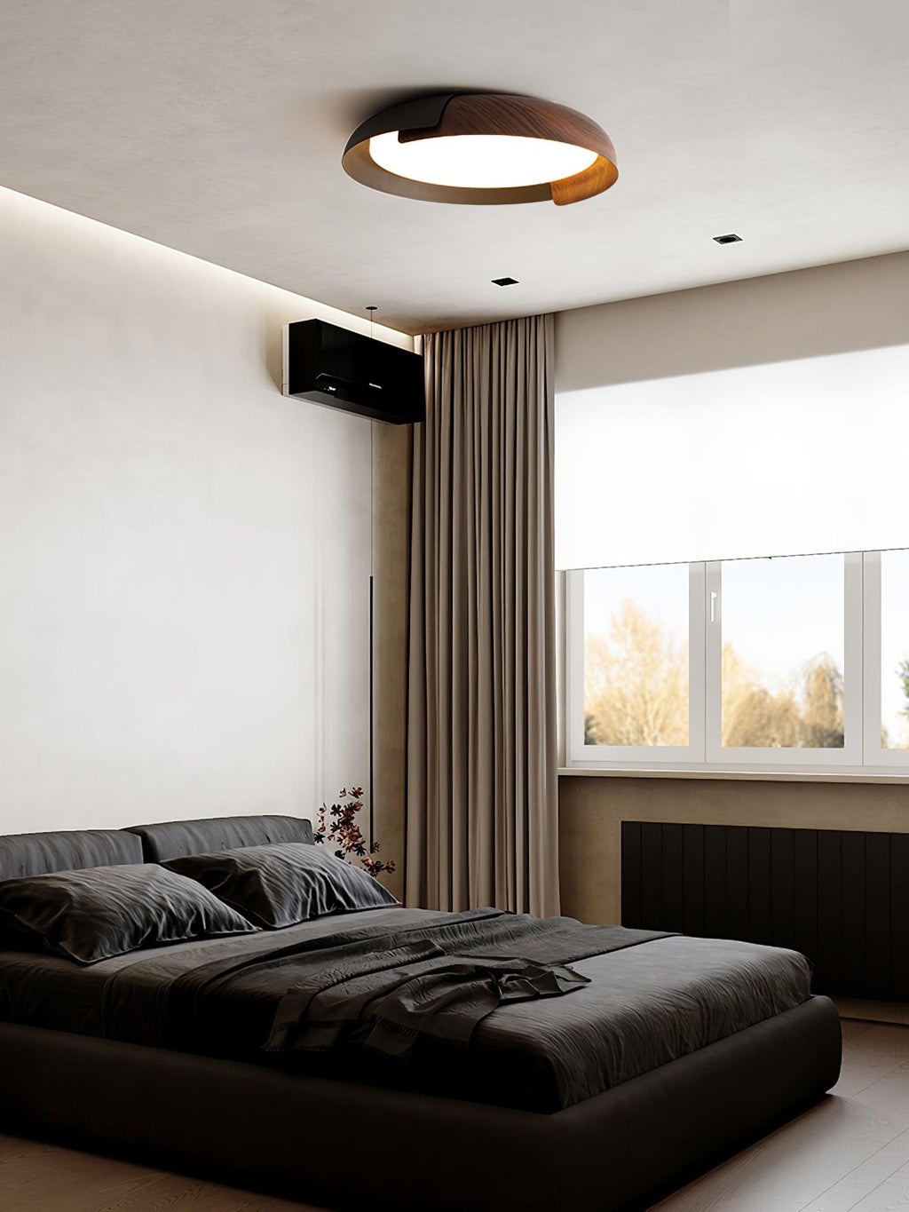 A black and dark wood Clérachic ceiling light lit in a grey bedroom with dark bedding, brown curtains and a window.