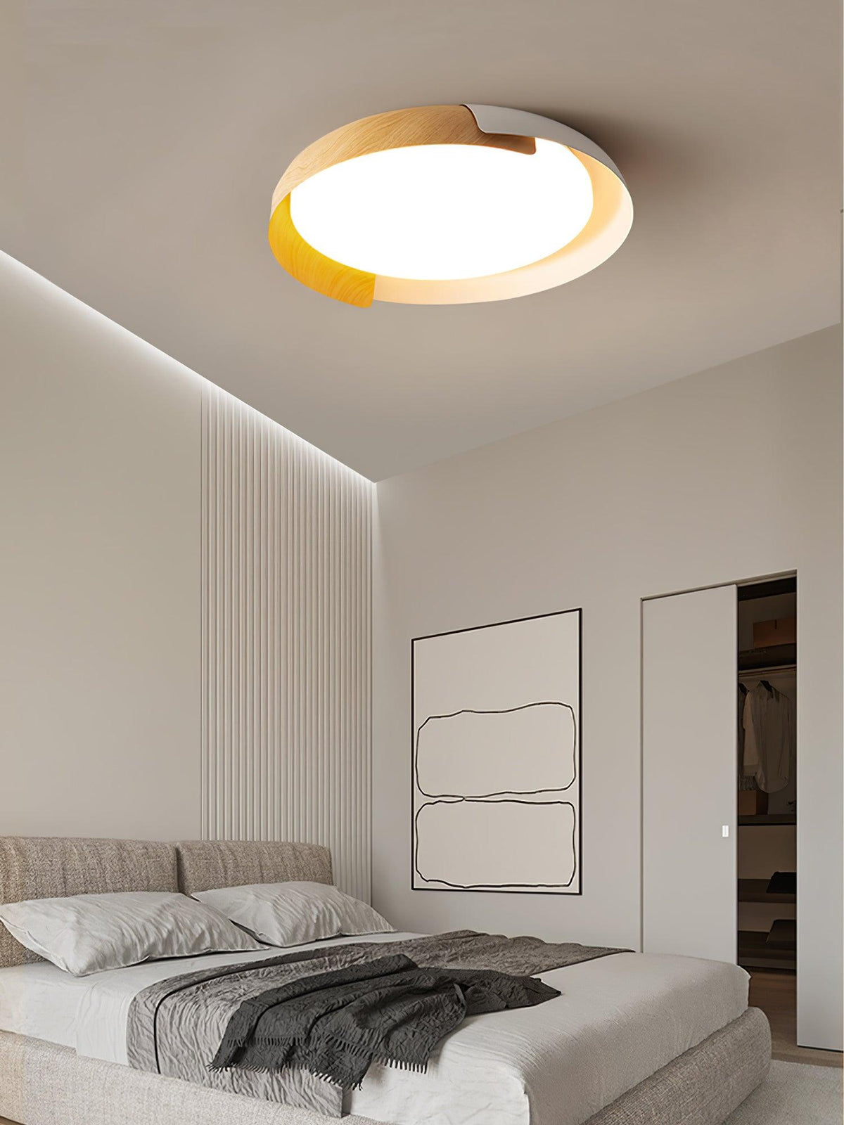 A light wood and white Clérachic ceiling light lit above a bed with grey bedding, beside a pale slatted wall and a line-art print.