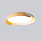 A light wood and white Clérachic ceiling light, shown from below with its frosted diffuser lit, on a soft grey backdrop.