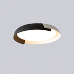 A black and grey Clérachic ceiling light with a dark wood accent, lit from below, on a soft grey backdrop.
