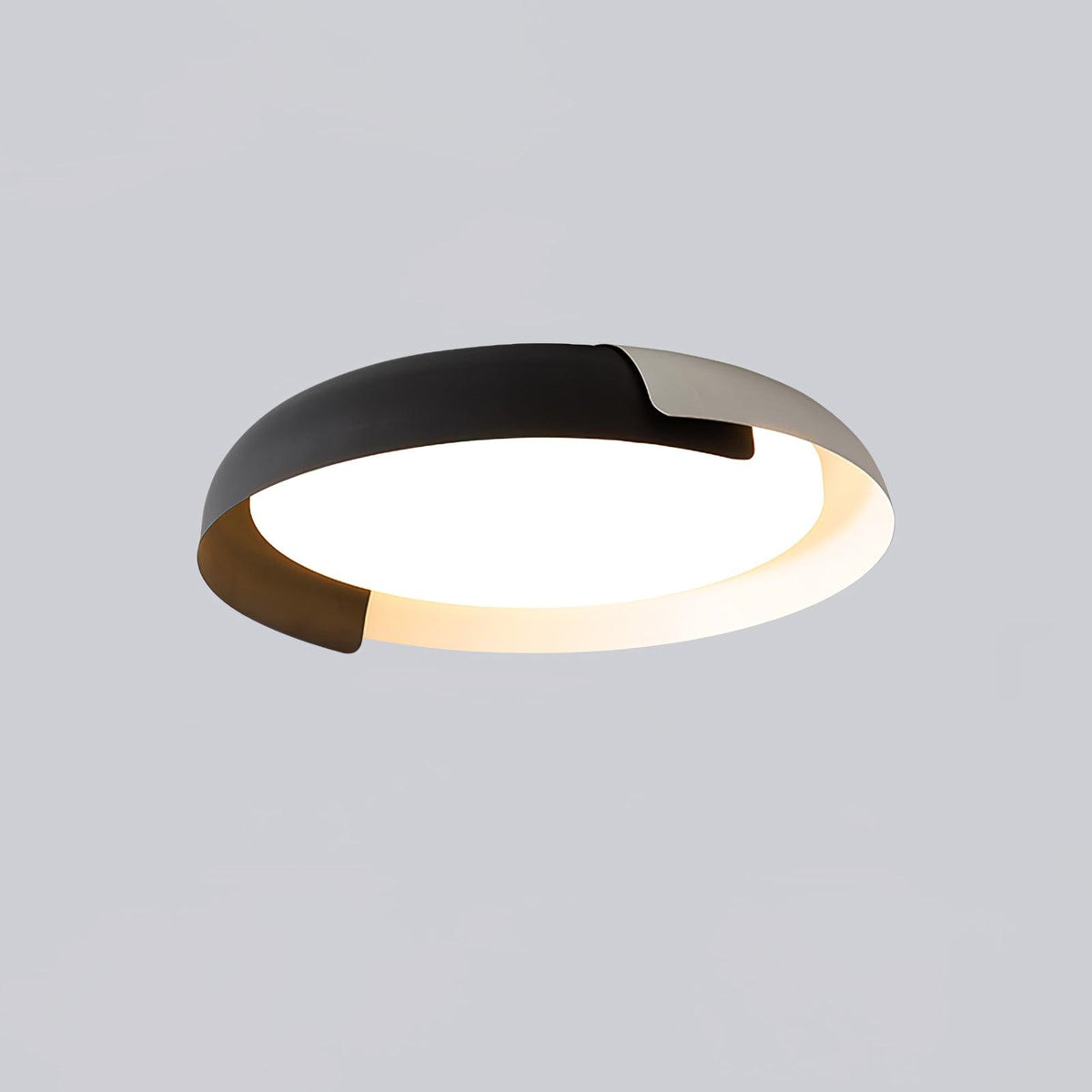 A black and grey Clérachic ceiling light with a dark wood accent, lit from below, on a soft grey backdrop.