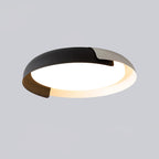 A black, white and dark wood Clérachic ceiling light, shown at an angle and lit, against a pale grey backdrop.