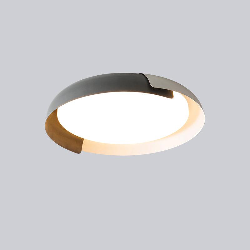 A grey and white Clérachic ceiling light with a wood-effect accent, shown lit on a soft grey backdrop.