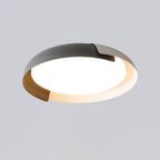 A grey, white and dark wood Clérachic ceiling light with a lit frosted centre, on a light grey backdrop.