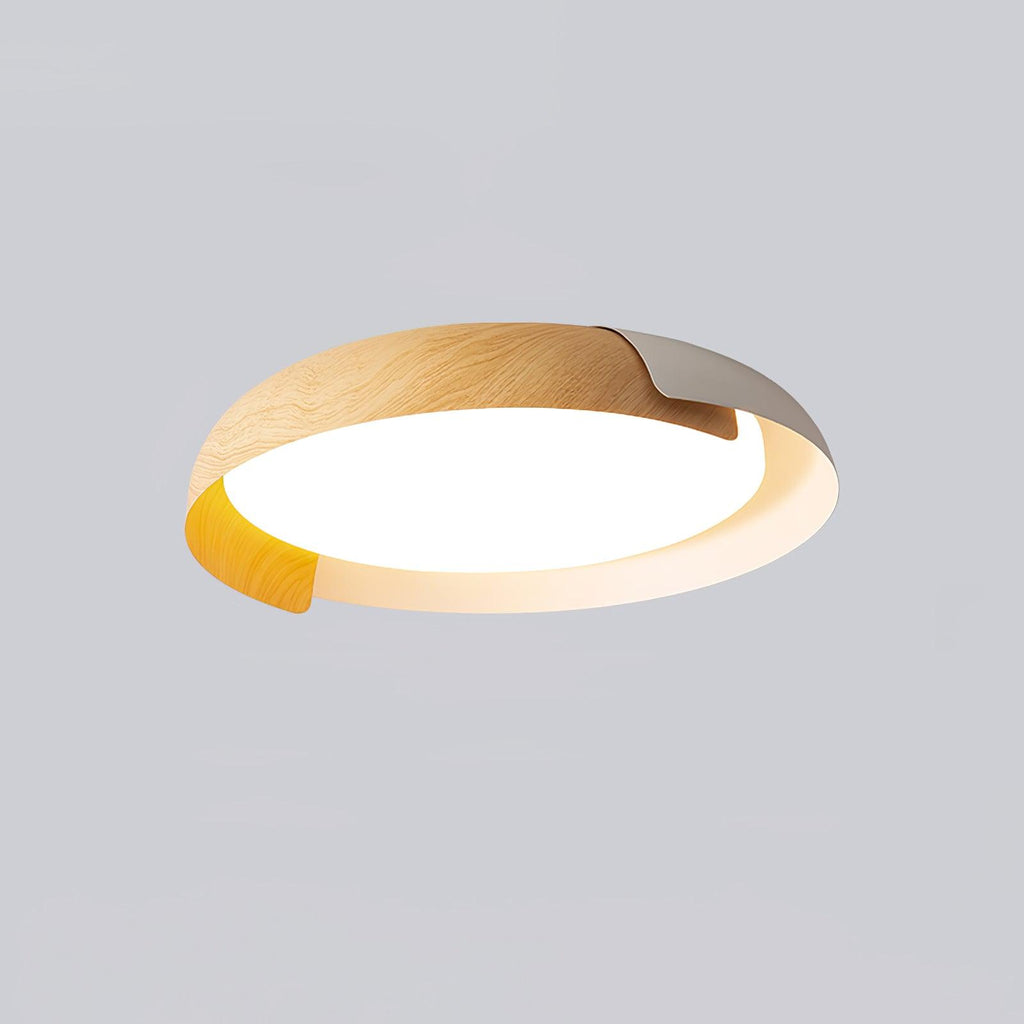 A light wood and white Clérachic ceiling light, lit and shown from below, on a soft grey backdrop.