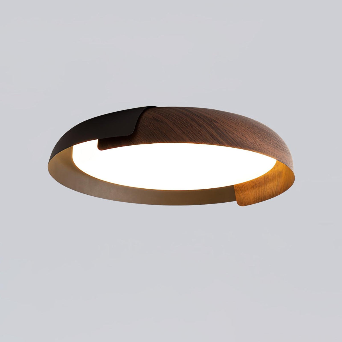 A black and dark wood Clérachic ceiling light with a bronze-toned inner rim, shown from the side on a grey backdrop.