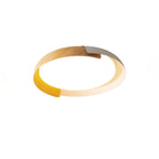 A small light wood and white Clérachic ceiling light with its inner glow visible, on a plain white backdrop.