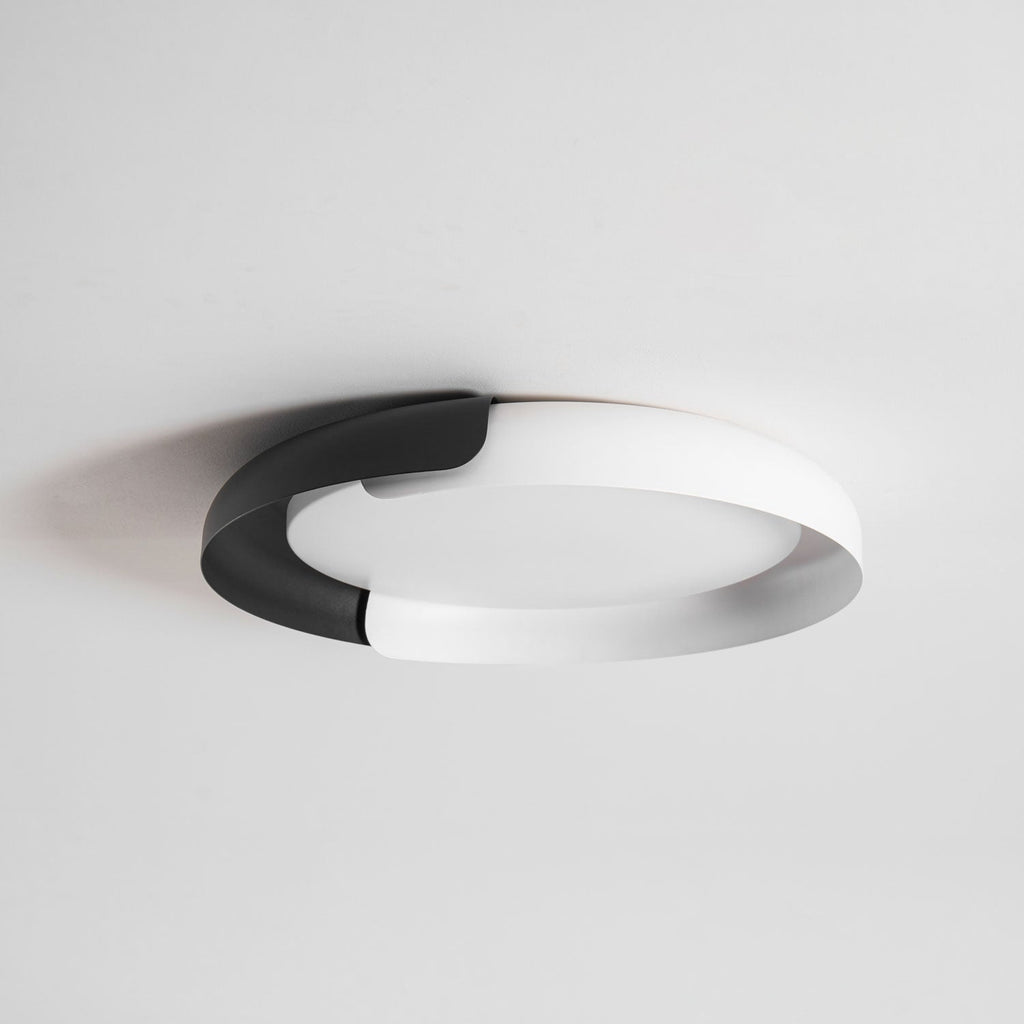 A white and black Clérachic ceiling light with a frosted diffuser, seen from below against a pale grey ceiling.