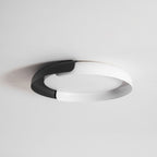 A white and black Clérachic ceiling light with a frosted diffuser, seen from below against a pale grey ceiling.