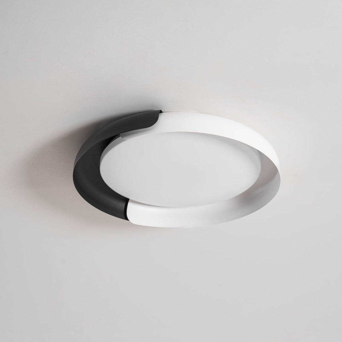 A white and black Clérachic ceiling light, shown unlit from below on a light grey backdrop.