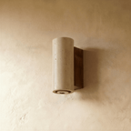 The Clérachic wall lamp's cylindrical stone shade and walnut base seen from a closer angle.