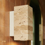 Close-up of the Clérachic wall lamp's rectangular stone shade and pale metal base on terracotta tile.
