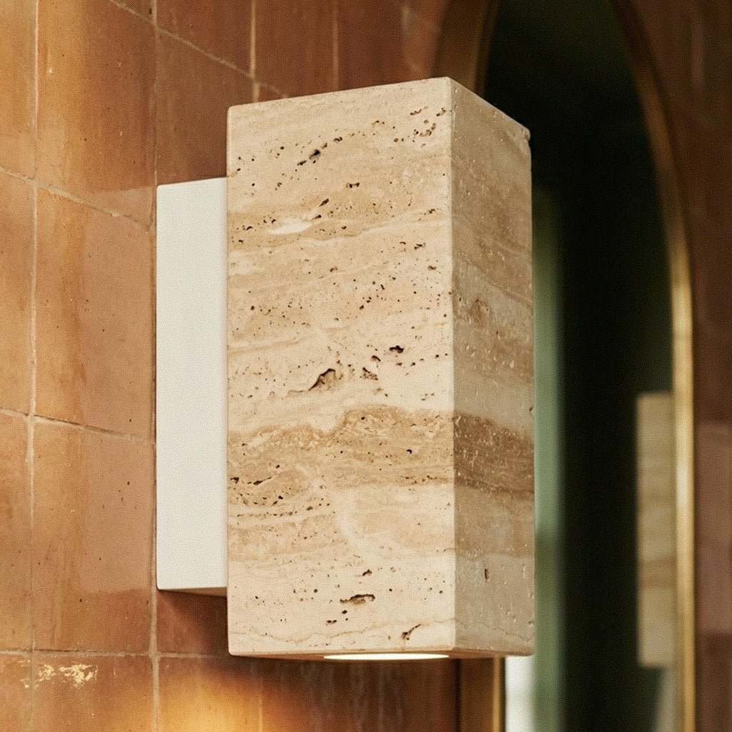 Close-up of the Clérachic wall lamp's rectangular stone shade and pale metal base on terracotta tile.
