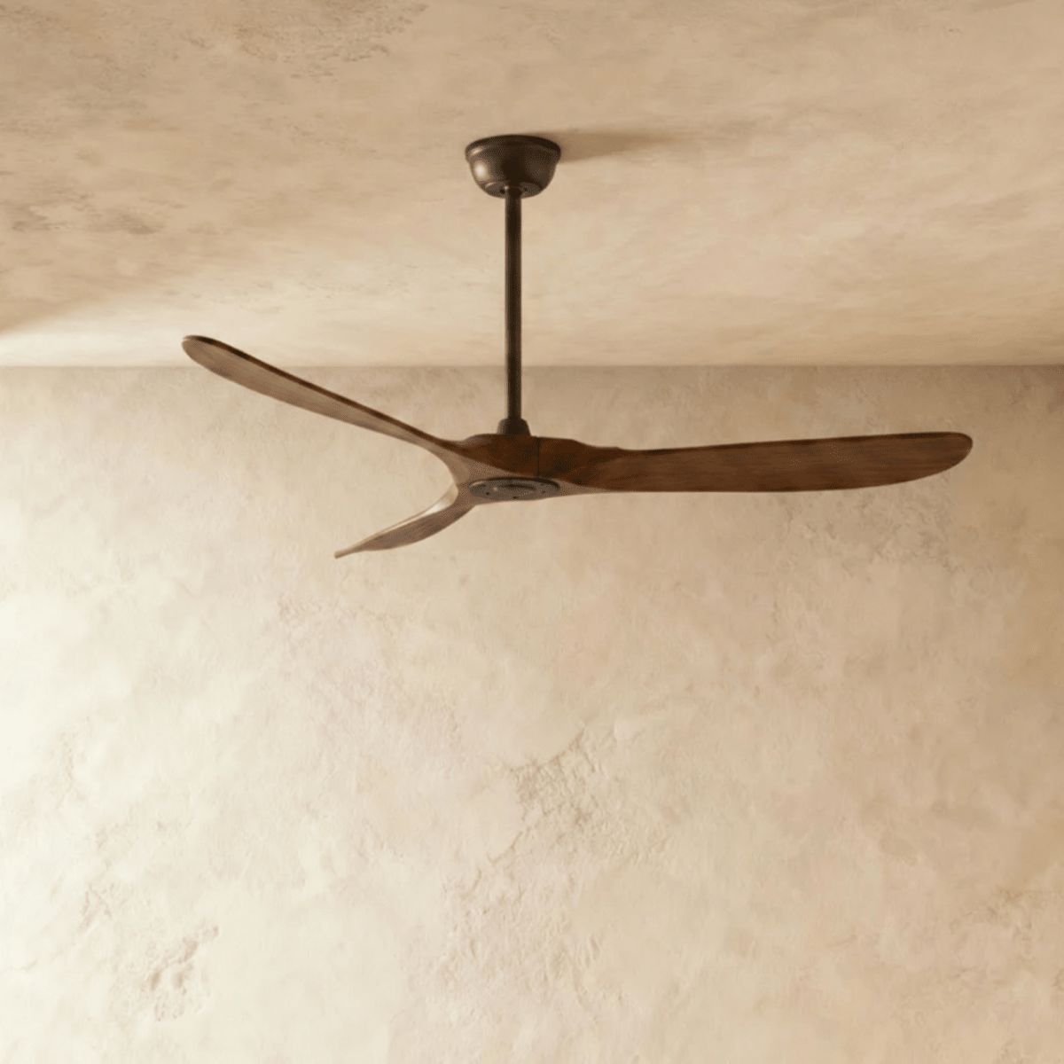 Clérachic three-blade ceiling fan in dark wood with a dark downrod and canopy, shown from a lower angle in the studio