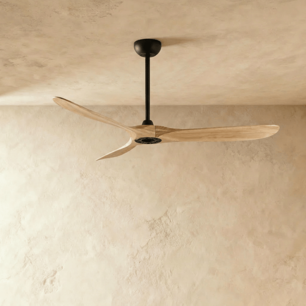 Clérachic three-blade ceiling fan with natural wood blades and a black downrod and canopy, photographed in the studio