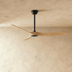 Clérachic ceiling fan in natural wood with a black body, three blades and a slim downrod, seen in the studio
