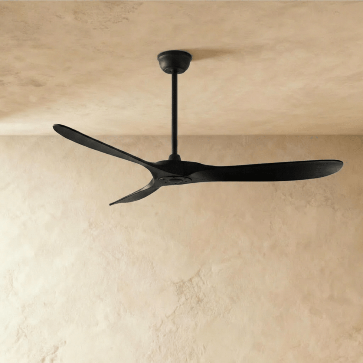 Clérachic three-blade ceiling fan finished entirely in black, with matching black blades, downrod and canopy, in the studio