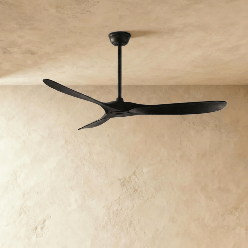 Clérachic all-black three-blade ceiling fan on a slim downrod, shown against a soft limewash backdrop in the studio