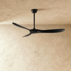 Clérachic all-black three-blade ceiling fan on a slim downrod, shown against a soft limewash backdrop in the studio