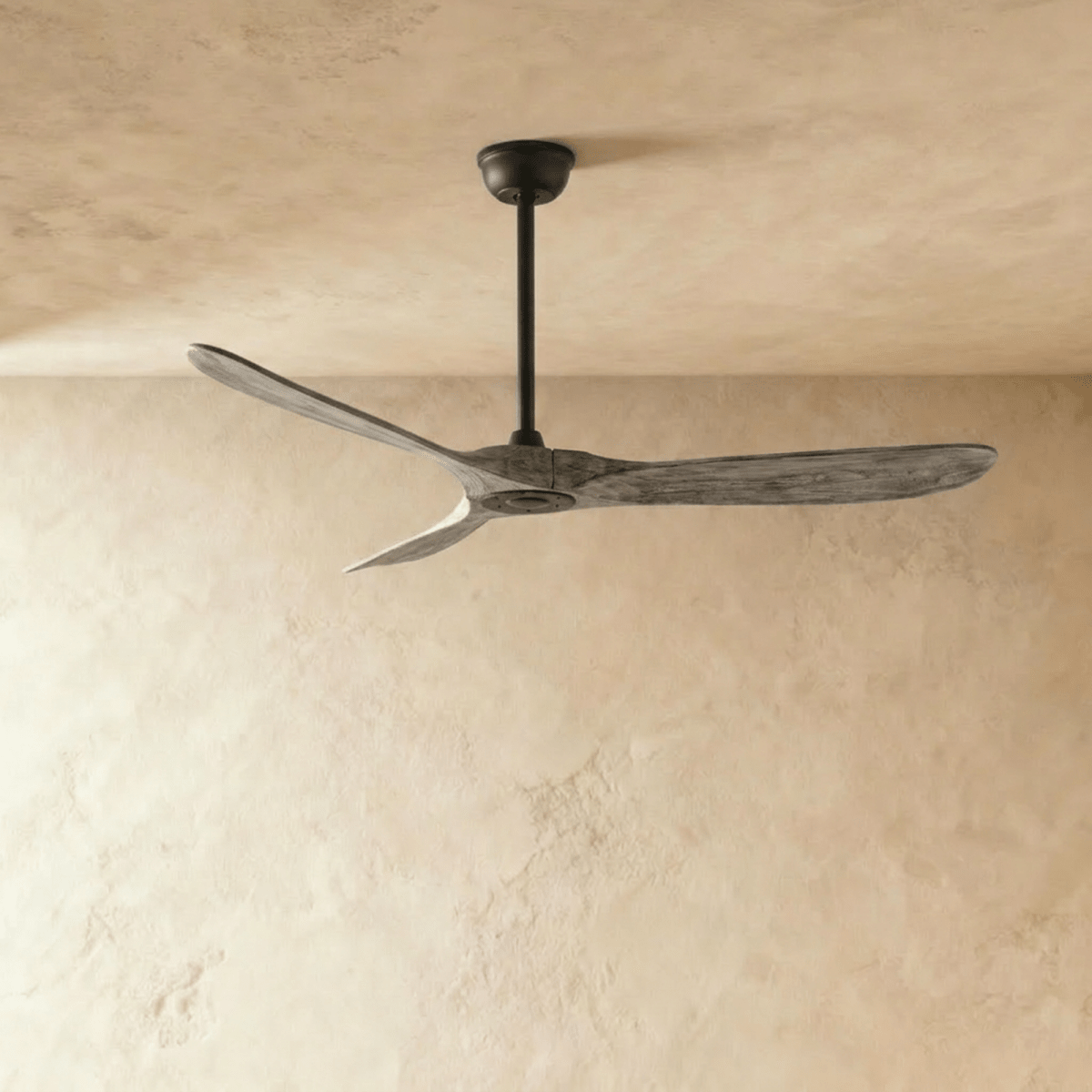 Clérachic three-blade ceiling fan with weathered grey wood blades and a black downrod and canopy, photographed in the studio