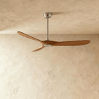 Clérachic three-blade ceiling fan with warm dark wood blades and a brushed nickel downrod and canopy, in the studio
