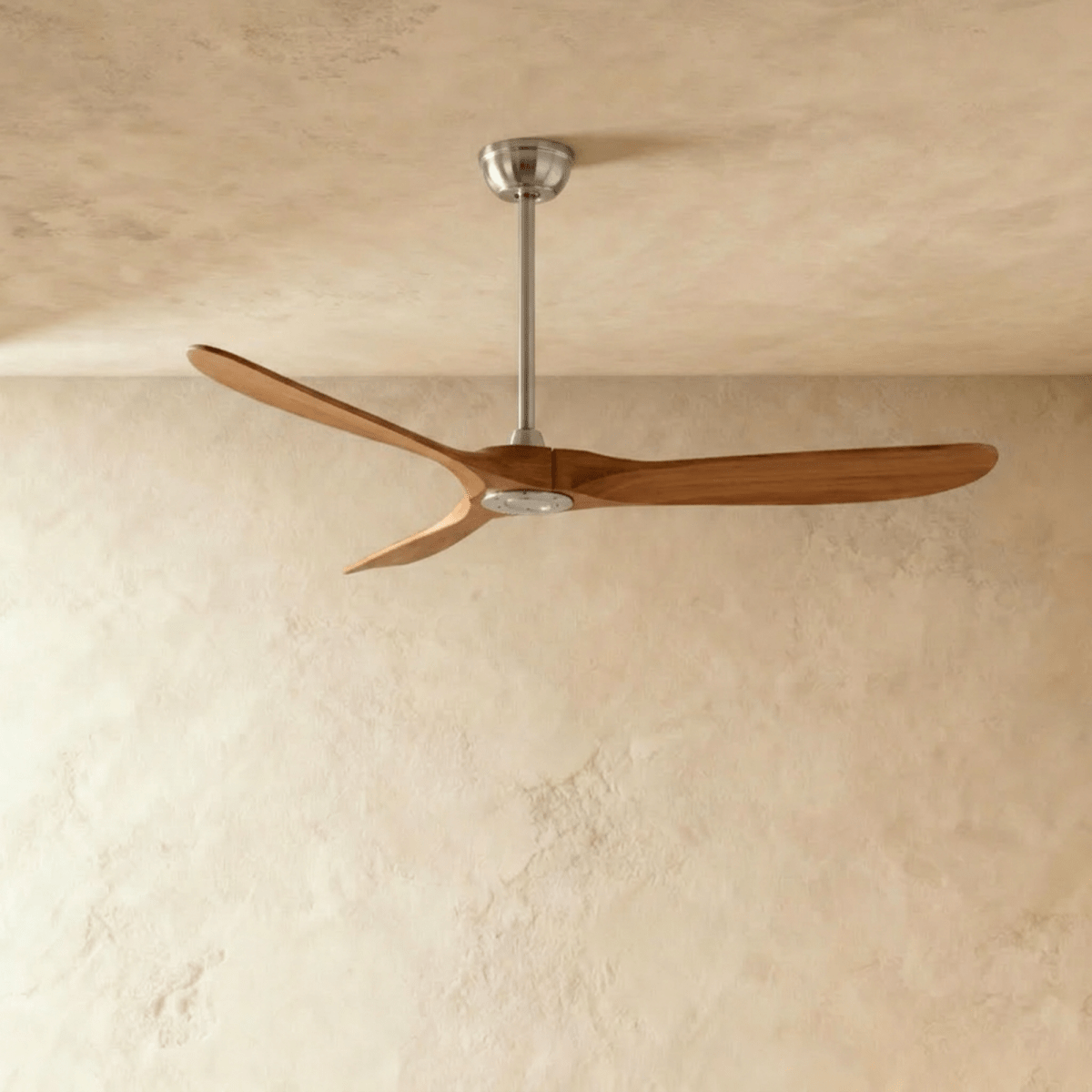 Clérachic three-blade ceiling fan with warm dark wood blades and a brushed nickel downrod and canopy, in the studio