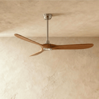Clérachic ceiling fan with dark wood blades and a brushed nickel body, seen on its downrod in the studio