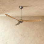 Clérachic three-blade ceiling fan in natural wood and nickel, with long curved blades on a slim downrod, in the studio