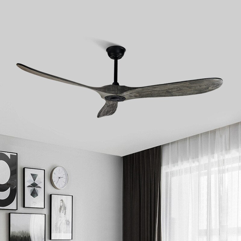 Clérachic three-blade ceiling fan with grey wood blades and a black downrod, hung in a bedroom with framed prints and curtains