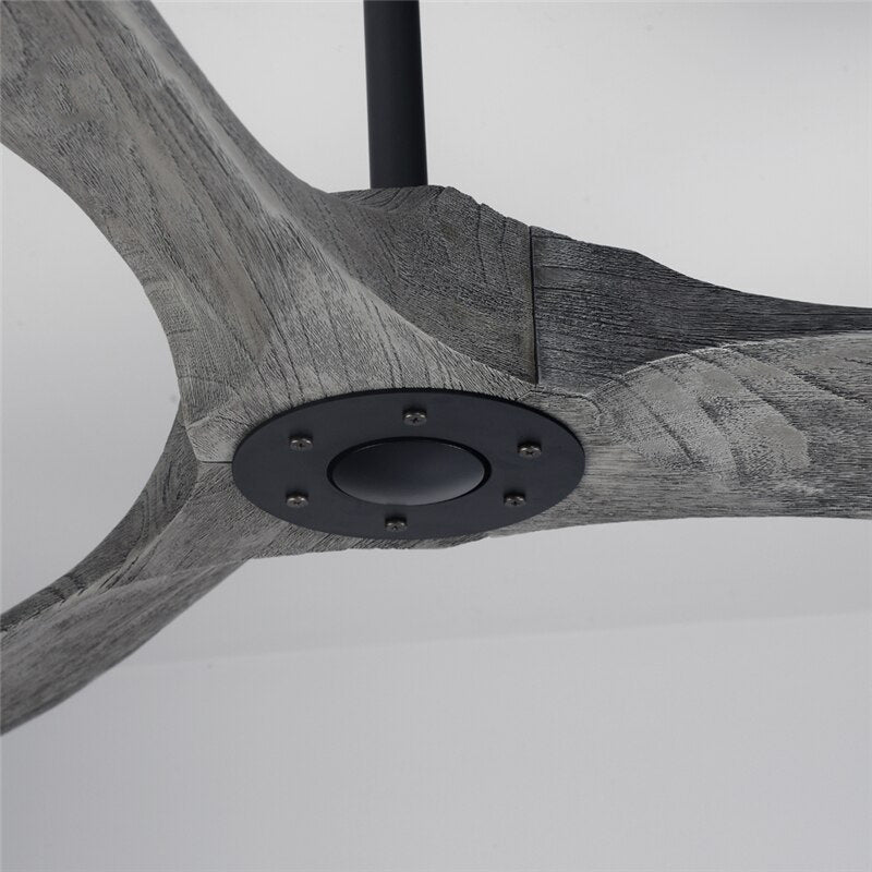 Clérachic ceiling fan close up of the grey wood-grain blades meeting at a black hub plate with six screws