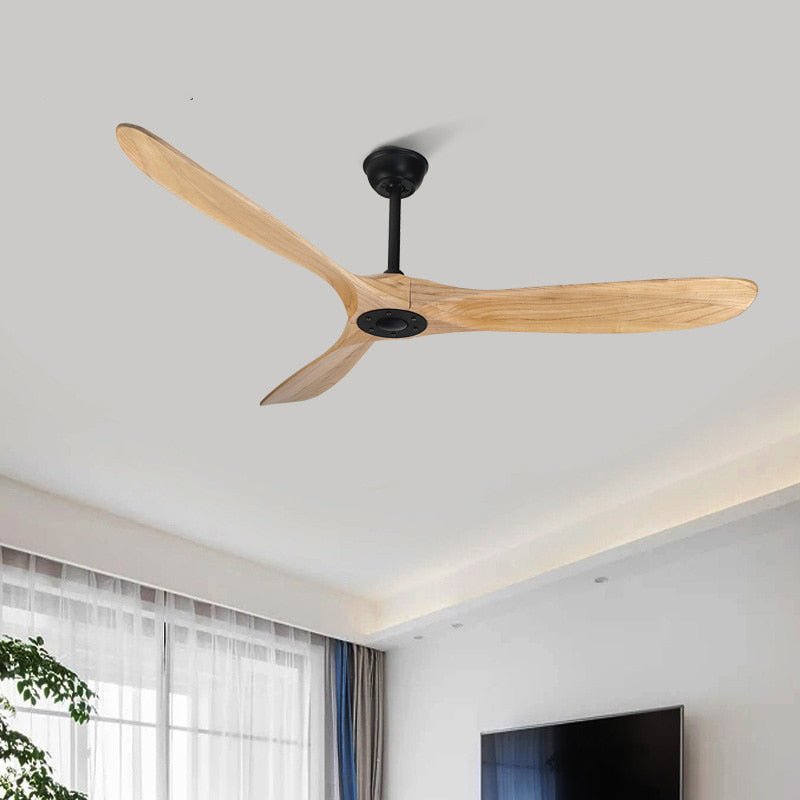 Clérachic three-blade ceiling fan with natural wood blades and a black hub, hung in a living room with a window and television