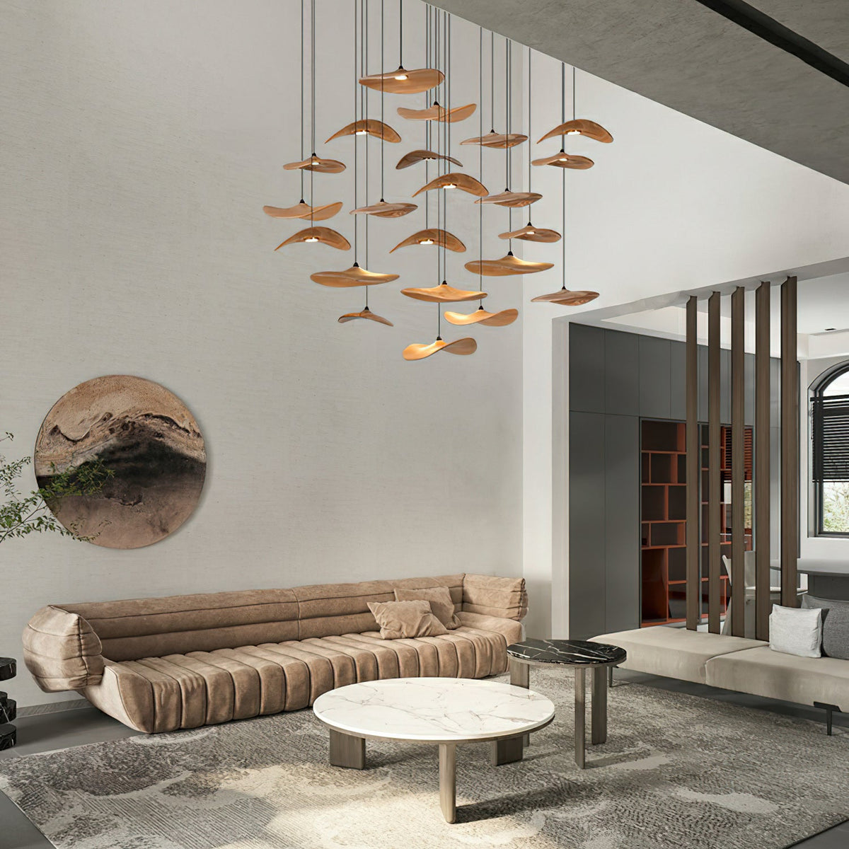 A large cluster of Clérachic wooden leaf pendants hanging in a double-height living room with a curved tan sofa.