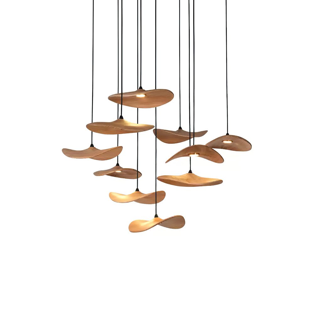 Twelve Clérachic wooden leaf pendants in a loose cluster on slim black cables, shown on a plain white background.