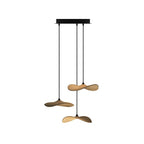 Three Clérachic leaf pendants in light wood hanging from a black canopy at different heights, on white.
