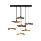 Cluster of light wood Clérachic leaf pendants of varied heights from a black rectangular canopy, on white.