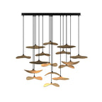 Wide cluster of Clérachic leaf pendants in mixed wood tones, hung at many levels from a long black canopy.