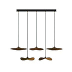 Five Clérachic leaf pendants in walnut colour on a black bar canopy, hanging at two alternating heights.
