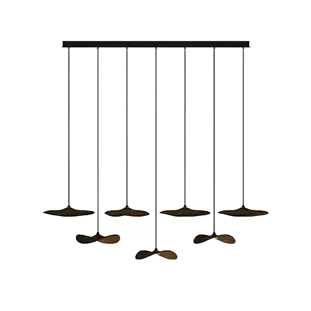 Seven Clérachic leaf pendants in dark walnut colour on a long black bar canopy, at alternating heights.