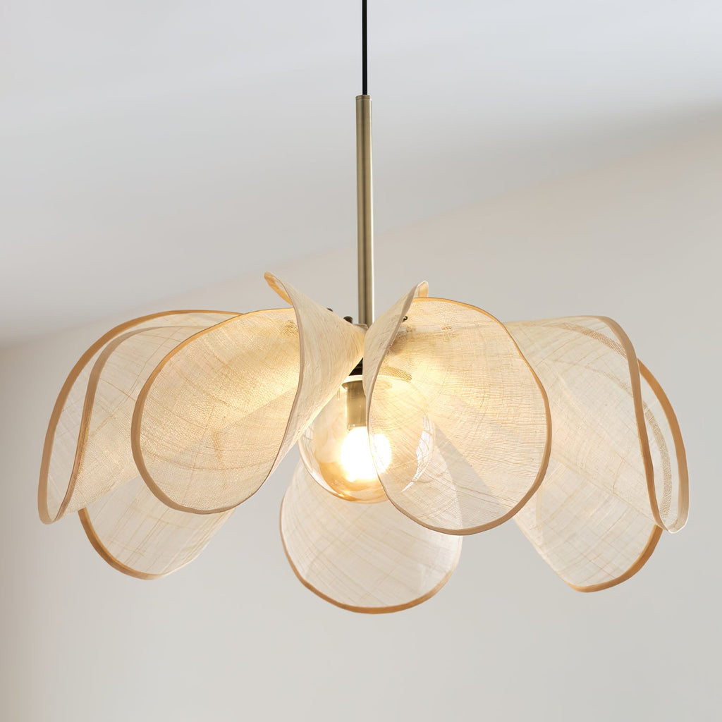 Close angle on the rounded bulb and curling beige petals of this Clérachic pendant in a bright white room.