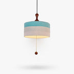Blue and white woven drum shade with a wooden pull-chain bead on this Clérachic pendant, on a plain white backdrop.