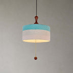 Close view of the blue and white woven drum shade, wooden finial and beaded pull chain on this Clérachic pendant.