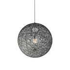 A black woven spherical Clérachic pendant light, unlit, with a bulb visible inside, on a black cord against white.