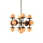 Clérachic Xenon chandelier shown against white, brass arms carrying a cluster of alabaster globes on disc reflectors.