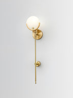 The Clérachic sconce shown full length on white, brass crescent above a tapering stem with a mid-stem collar.
